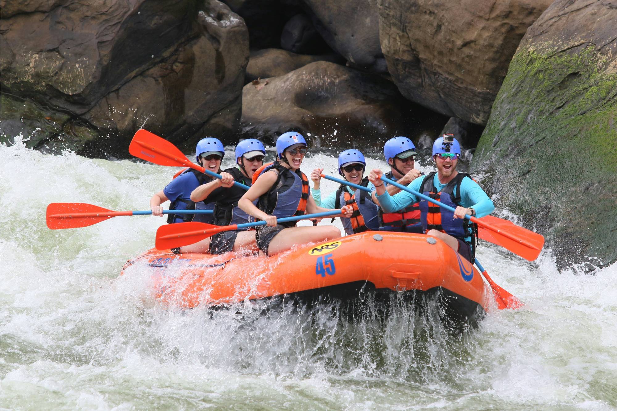 group of people rafting through whitewater
